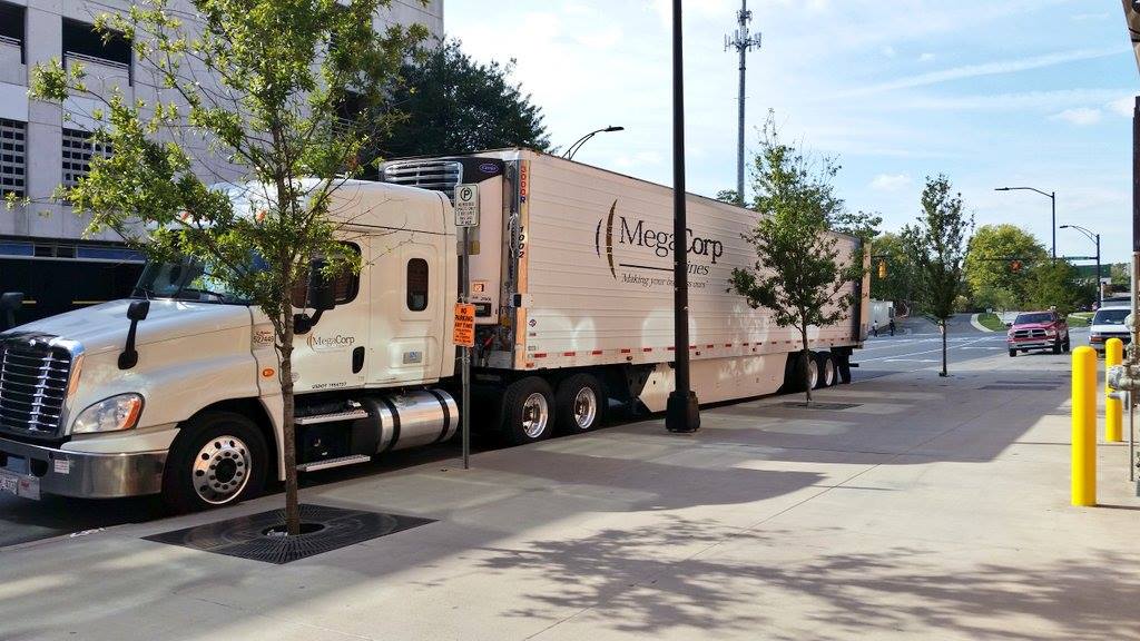 A MegaCorp Lines truck parked on a city street.